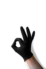 Hands in medical black gloves represent OK on a white background