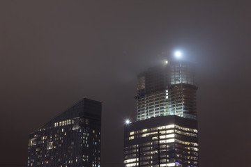 A light shines on a building in the fog of Philadelphia, USA