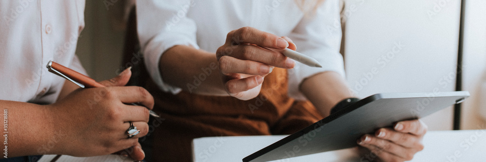 Wall mural business people working with a digital tablet in a meeting