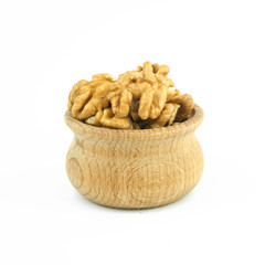 Walnuts in wood bowl close up isolated on white background.