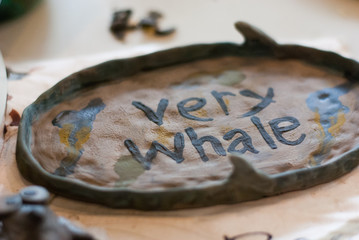 Unfinished ceramic work, a plate with text 