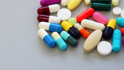 Top view multi-color tablets, pills, and capsules medicine use for treatment and cure the disease or sickness. Drug prescription use for medication in medical clinic, pharmacy Pharmaceutical service.