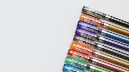 Close up colorful pens rainbow isolated in white background has copy space for text, using for studying in school class room, back to school template learning concept, can use as PowerPoint template.