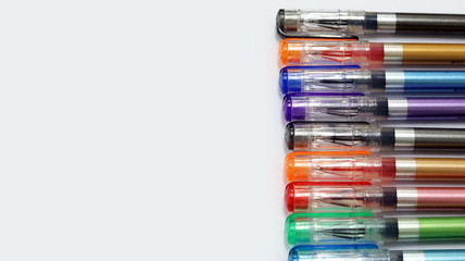 Close up colorful pens rainbow isolated in white background has copy space for text, using for studying in school class room, back to school template learning concept, can use as PowerPoint template.