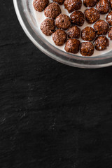 chocolate milk cereal balls bowl on the black background