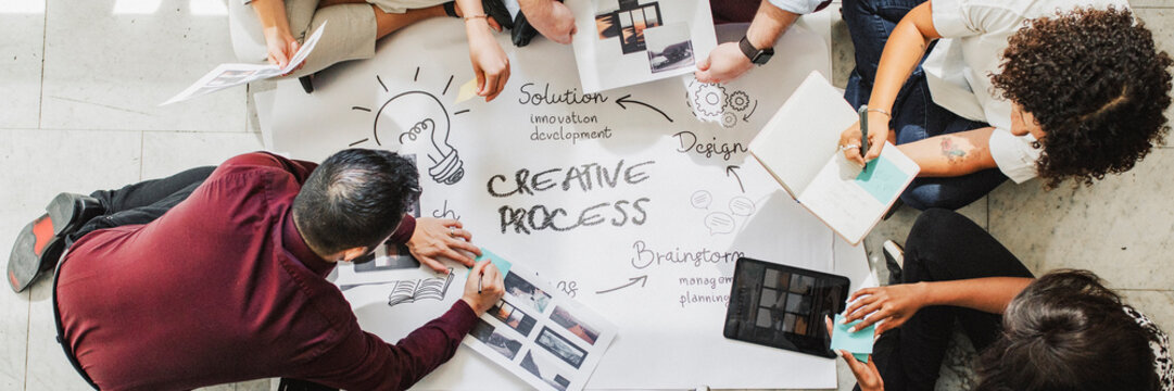 Business people brainstorming ideas using a chart