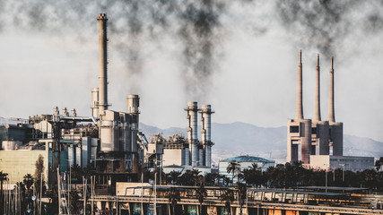 Fototapeta na wymiar Industry skyline with smoking chimneys with polluted sky.