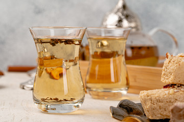 Turkish halva with tea in a glass cup close up
