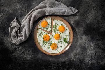 Fried eggs on a ceramic plate with herbs