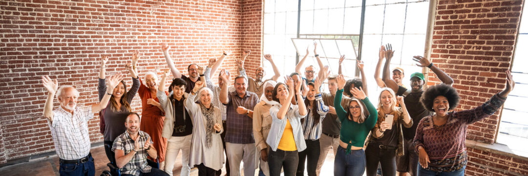 Group Of Diverse People Standing In Front Of A Brick Wall