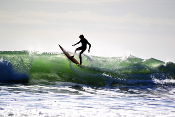 Raglan, New Zealand - March 2016: Surfing The Beach in Raglan