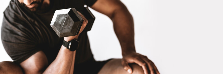 Bodybuilder lifting dumbbells in the gym