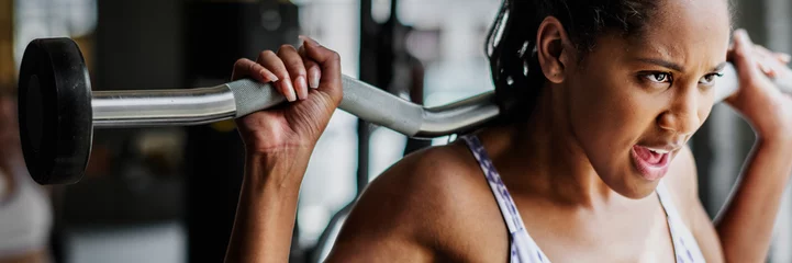 Papier Peint photo Fitness Woman exercising weighlifting with barbell at fitness gym