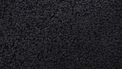 Fototapeta premium Fresh asphalt. Black structural background. Side view