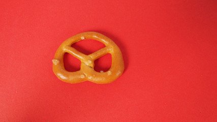 One Mini Pretzel on red background.