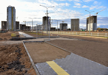 Laying paving slabs and borders at construction site. Process of installing paving bricks in the...