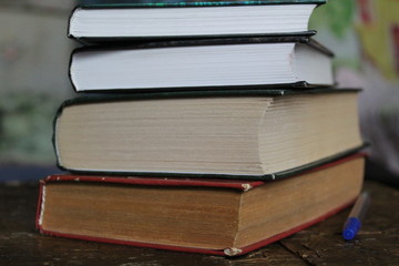 a stack of old and new books on the table