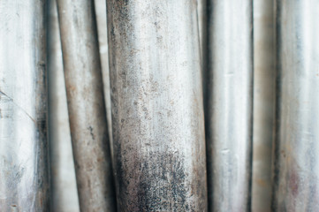Stainless steel scrap metal, stainless steel pipes on the background of a stainless steel sheet....