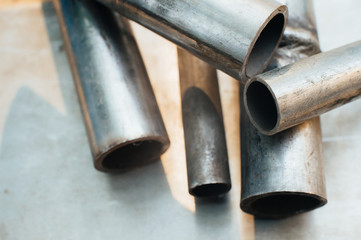 Stainless steel scrap metal, stainless steel pipes on the background of a stainless steel sheet....