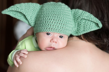Newborn baby in the crotchet green cap with ears looks like one famous  "star master" character. The very first cosplay.