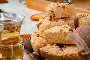 Turkish halva with tea in a glass cup close up
