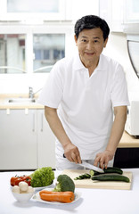 Senior man preparing food in the kitchen