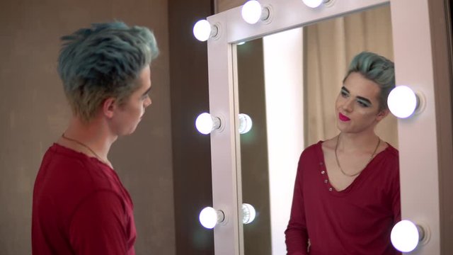 homosexual man put make up in mirror transvestite, travesti diva show