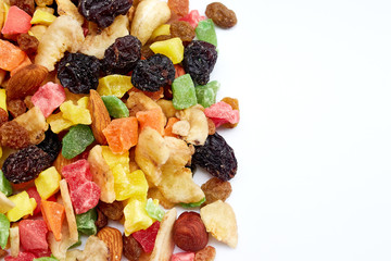 Assorted different dried sweets. Dried bananas, grapes, nuts. On the left.