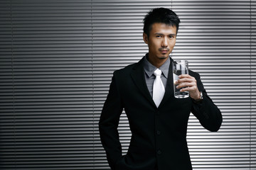 Businessman holding a glass of water