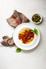 Pasta penne with meat sauce on white plate