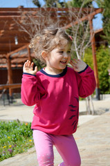 Portrait of Happy Child Girl Dancing Outdoor 
