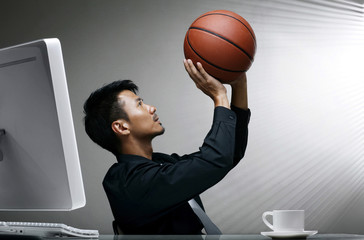Businessman trying to shoot a basketball