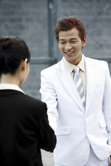 Businessman and businesswoman shaking hands