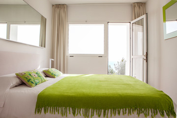 Interior design in bedroom of pool villa with cozy king bed. Bedroom with green and white colors