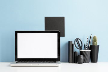 Laptop at trendy home office and books around, Homeschooling concept. Creative desk.	