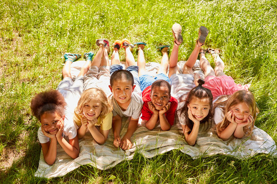 Group of multicultural kids on a meadow