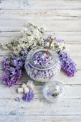 Lilac flowers and sugar in a glass jar