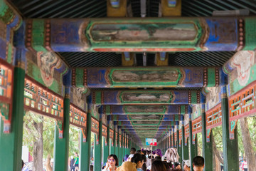 People walking in the beautiful pathways of Summer Palace, Beijing, China on a hot summer day