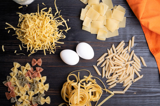 recipe of  of italian pasta on dark wooden table. dry pasta background