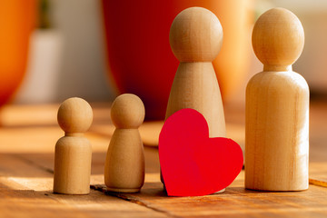 Small wooden figures of family members. Family relationship symbol