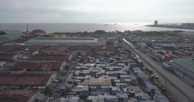 Ungraded, Backtracking aerial flight over squatter area then ascending. Drone, 4K. 