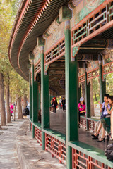 People resting in the beautiful pathways of Summer Palace, Beijing, China on a hot summer day