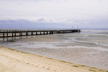 Andernos beach at low tide with the city pontoon big pier