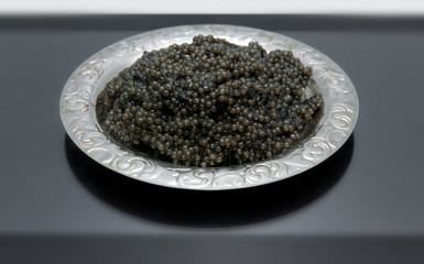 black caviar on a beautiful silver plate