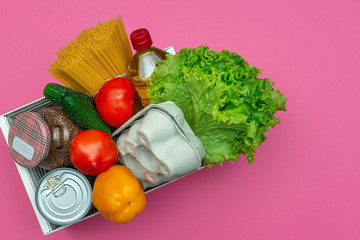 Food box on a pink background, top view