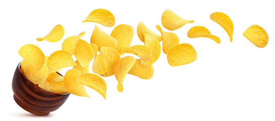 Potato chips falling into wooden bowl isolated on white background