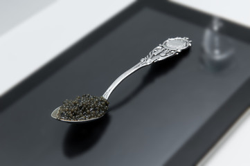 black caviar on a beautiful silver tea spoon