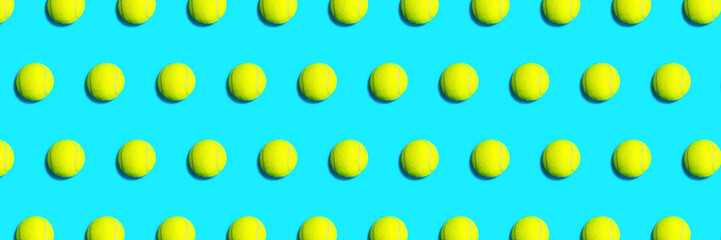 Trendy pattern made of tennis ball on blue green mint background. Sport tennis layout. Flat lay.