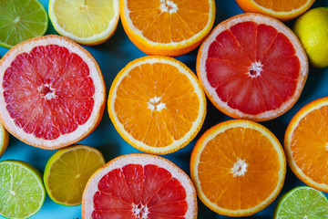 Colorful sliced citrus - oranges, grapefruits, lemons and limes close-up. Filled frame