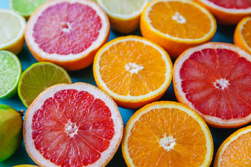 Colorful sliced citrus - oranges, grapefruits, lemons and limes close-up. Filled frame